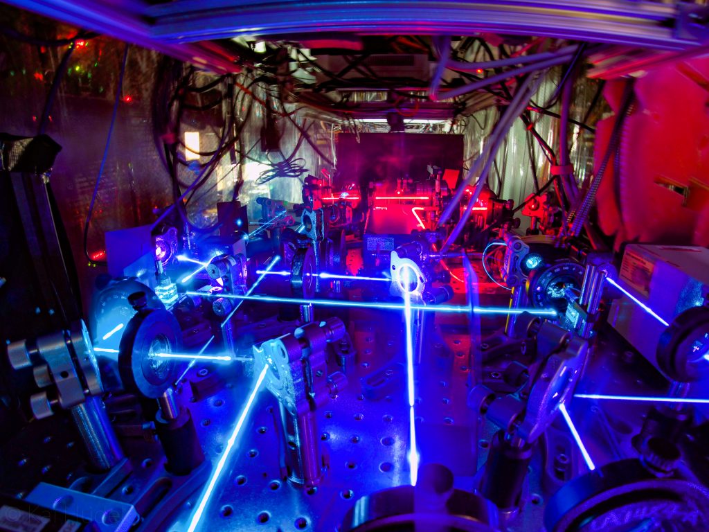 Blue and red lasers bouncing between mirrors on a table